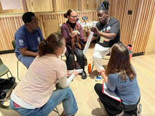 Teaching artists and educators work together during an immersive arts activity